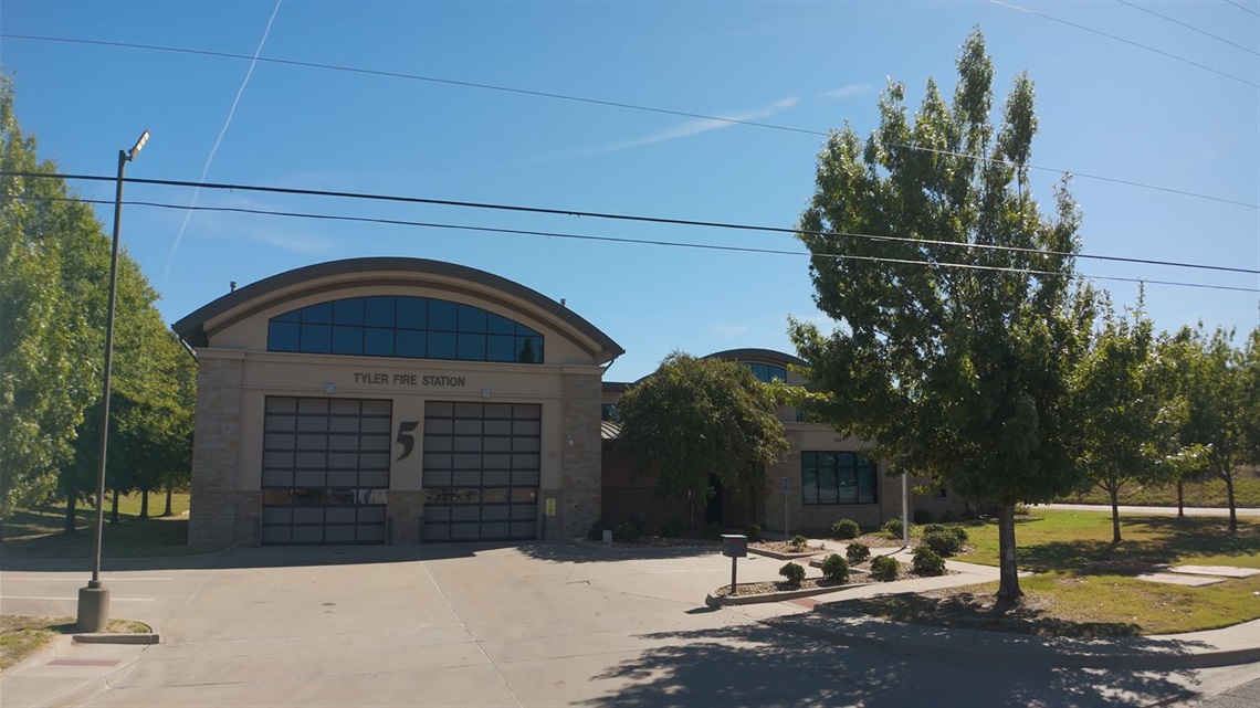 A fire station with trees out front